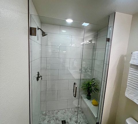 Shower with custom tile walls and floor pan.