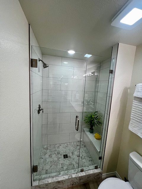 Shower with custom tile walls and floor pan.