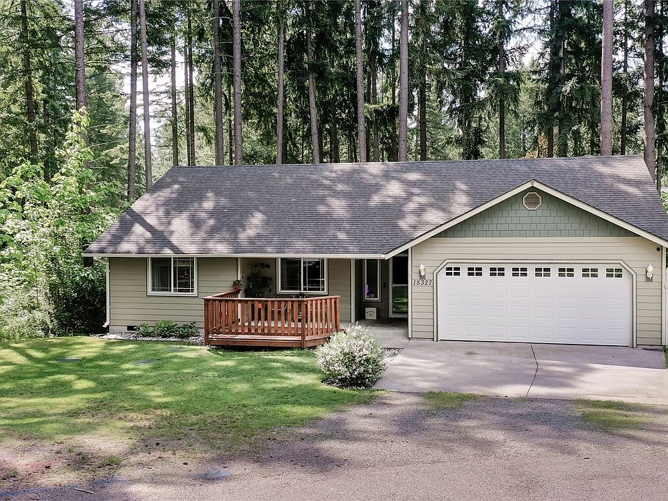 Front of home, note new deck and trees surrounding the property.>