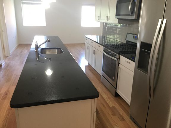 Kitchen in foreground. Living room in background.
