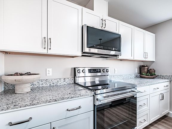 Contemporary kitchen design with premium stainless steel appliances, spacious granite countertops, and ample cabinetry for convenient everyday living.
