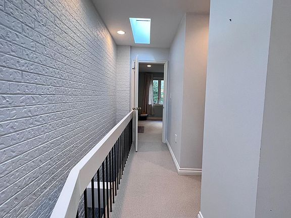Hall way toward master bedroom with skylight above.