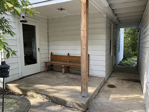 The front porch and breezeway. The breezeway leads to the double garage.