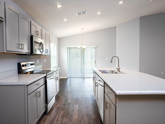 Open kitchen with Counter-height Island - New home for sale in Eagle Lake, FL. Photo showcases the h
