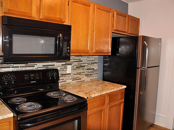 Kitchen appliances - stove, over the range microwave, stainless refrigerator.