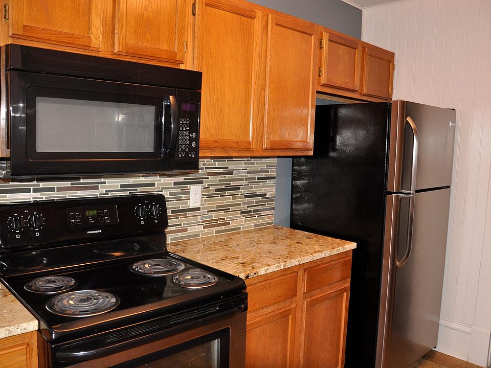 Kitchen appliances - stove, over the range microwave, stainless refrigerator.