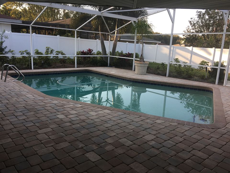 Caged pool with brick pavers