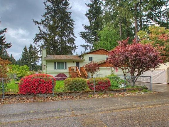 Oversized 2 car garage with RV parking to the right of the garage.