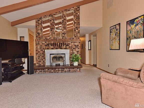 Vaulted open beam ceilings enhance the beauty of this spacious great room. 