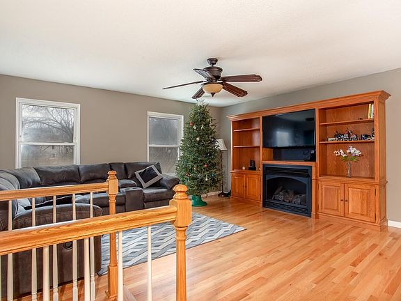 Great room has beautiful flooring, a custom built entertainment center with gas fireplace (stays) and is open to the kitchen and dining area.