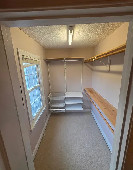 Bedroom 2: walk-in closet with wall-mounted racks