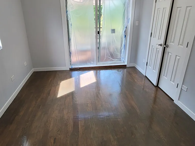 Primary bedroom with a large closet space and a walkout deck area with patio furnitures