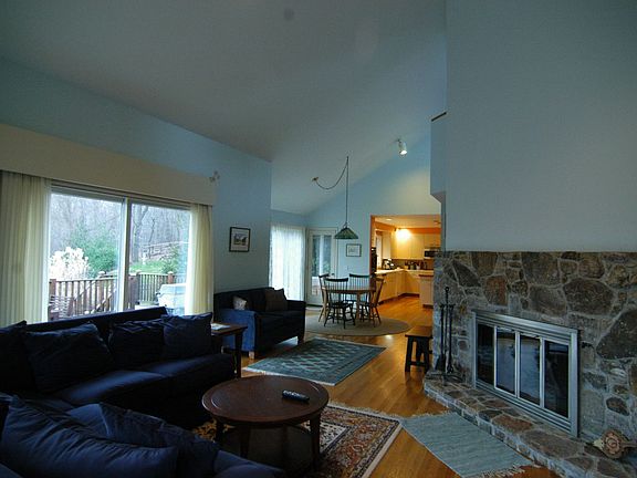 Family Room with stone fireplace and doors to Deck