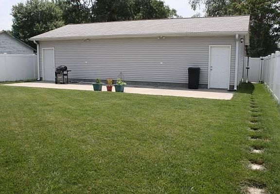 Detached over-sized garage stalls, concrete patio