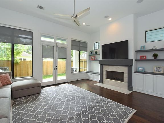 Elegant tile around fireplace with wood mantle.  Fireplace is both gas and wood burning.