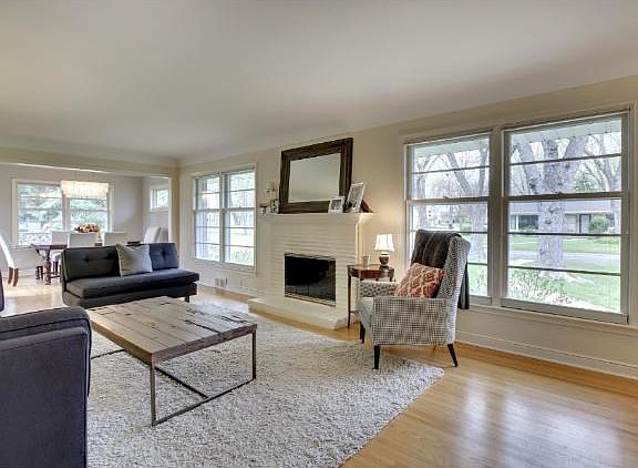 Note all the windows and light! Gas fireplace is a cozy touch - plenty of space to hang out and entertain.