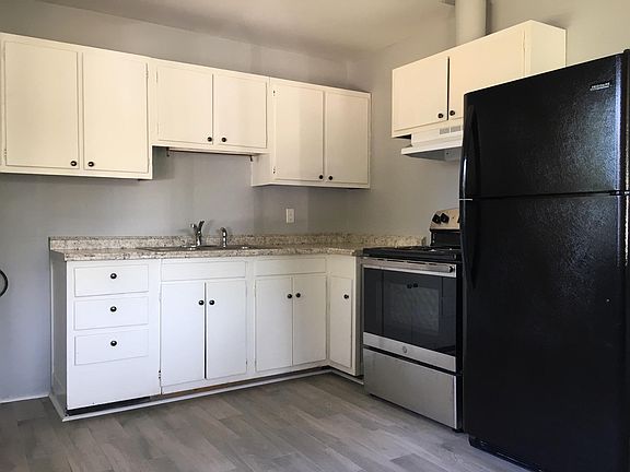Kitchen renovations include new appliances, counter tops, sink and porcelain tile floors.