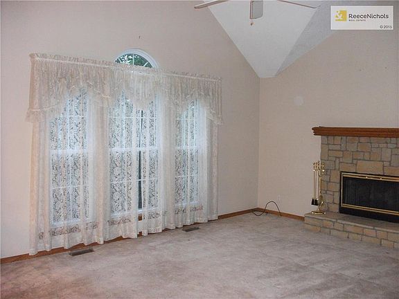 LIVING ROOM WITH FIREPLACE AND VAULTED CEILING