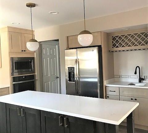 Refrigerator, bar sink and wine rack in kitchen
