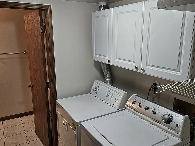 Bright / Spacious Laundry Area w/ White Cabinets and Shelf