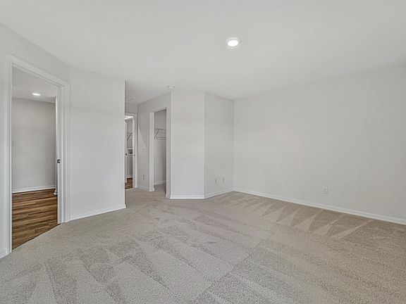 The spacious master bedroom with attached bathroom and walk-in closet