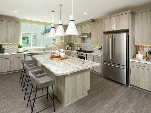 The kitchen brings joy with large kitchen island location superb for entertaining