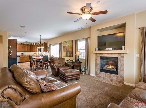 The great room seamlessly blends into the dining and kitchen and is also situated near the sliding d