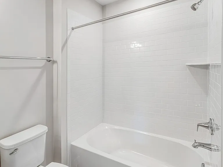 Well-appointed full bathroom conveniently located adjacent to the secondary bedroom.