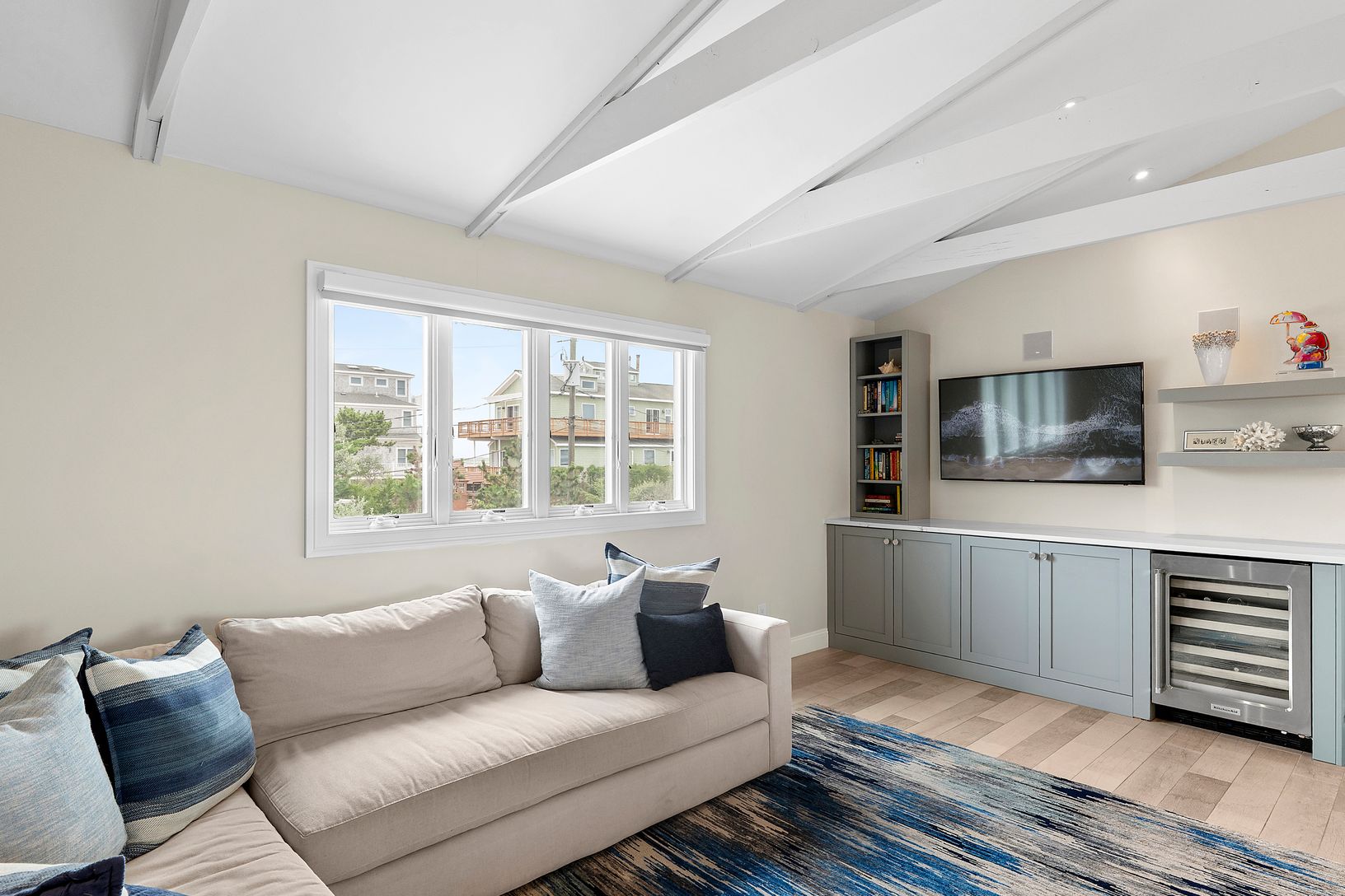 Open plan family room with built-in mini fridge.