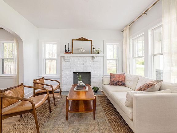 vintage living room, drenched in light! Windows which face south, north, and west serve this room