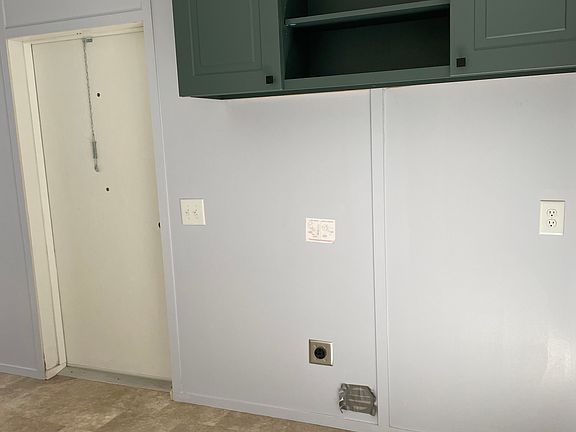 Washer, dryer hookup with storage cabinet above