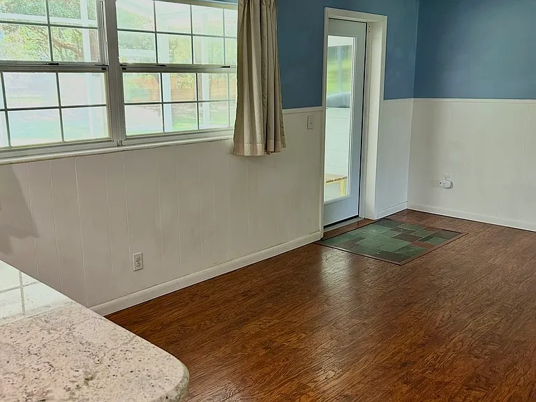 Room off kitchen/dining room. Leads to back porch