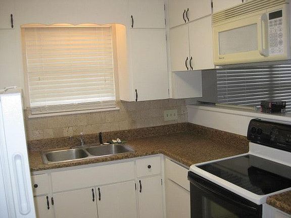 All cabinet are being refaced with new doors and painted. This is the photo with the old doors.