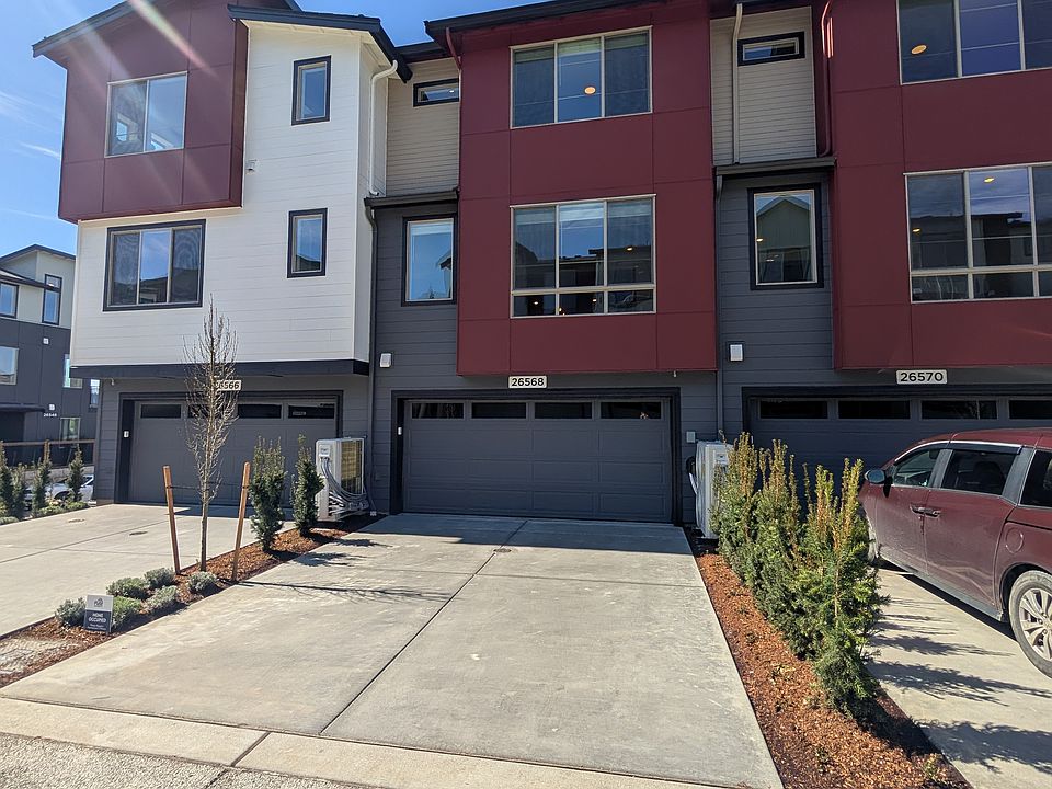The garage access is on the back or East side of the unit. There is room for cars to park in front of the garage door. Very handy when you have guests visit.