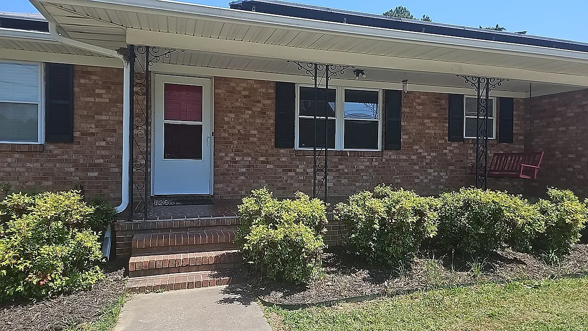 Beautiful large front porch with a swing, perfect for relaxing. Located in a lovely, neighborhood with great curb appeal. - 1300 Clingman St