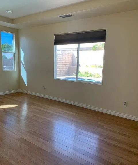Master bedroom with view out to pool.