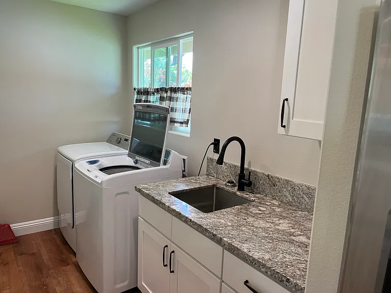 Laundry area off kitchen with door to carport