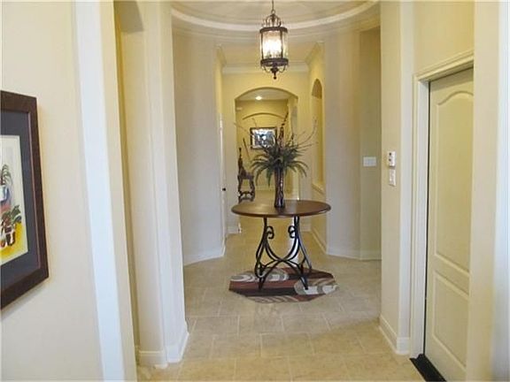   Beautiful Entry Way rounded entries, neutral paint, gambrelled ceilling, ceramic tile floors