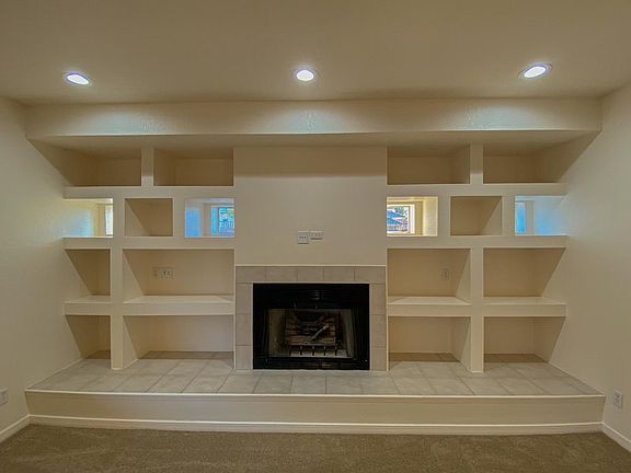 Gas fireplace in family room with lots of cubby holes.
