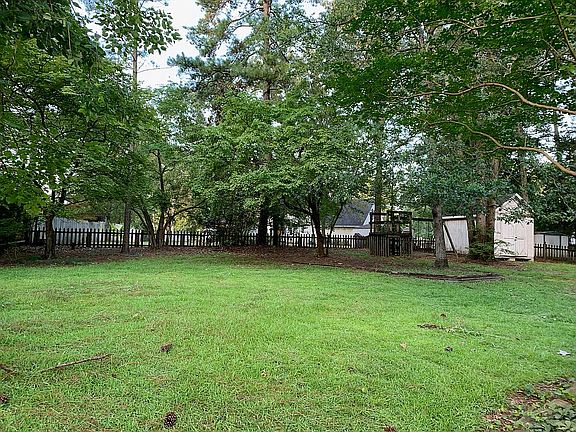 Fenced back yard with shed