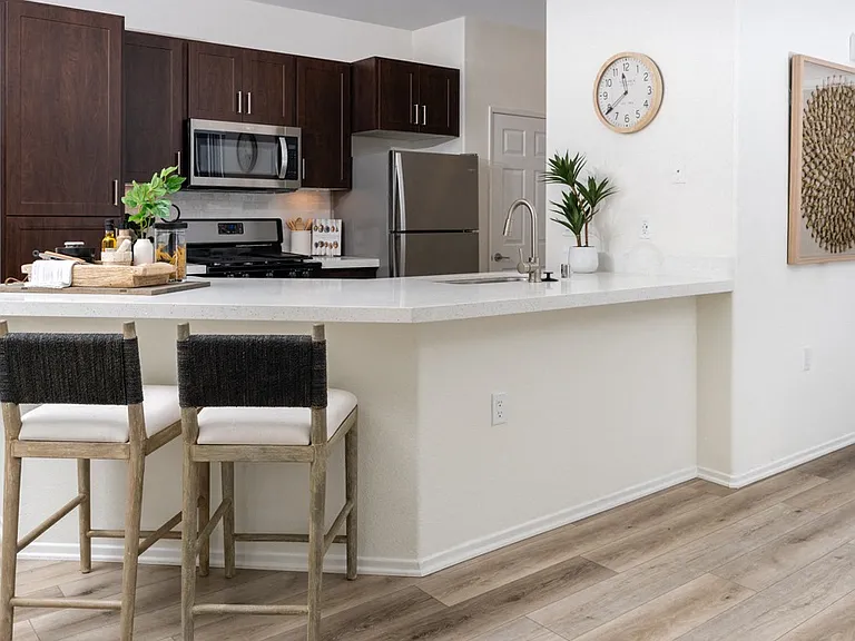 Bright Kitchen with Extended Countertop Seating and Decorative Wall Art