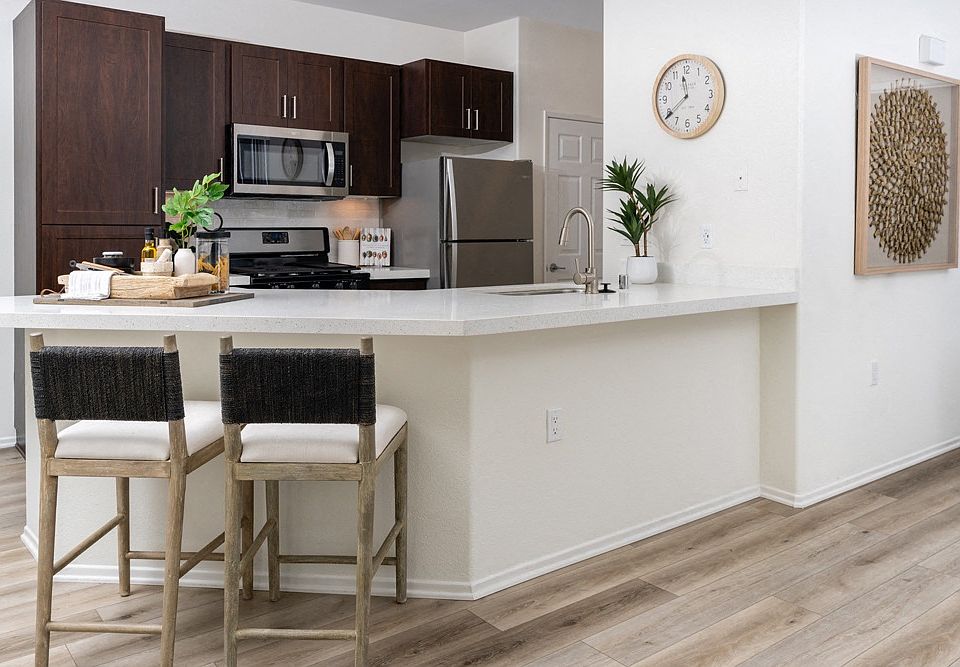 Bright Kitchen with Extended Countertop Seating and Decorative Wall Art
