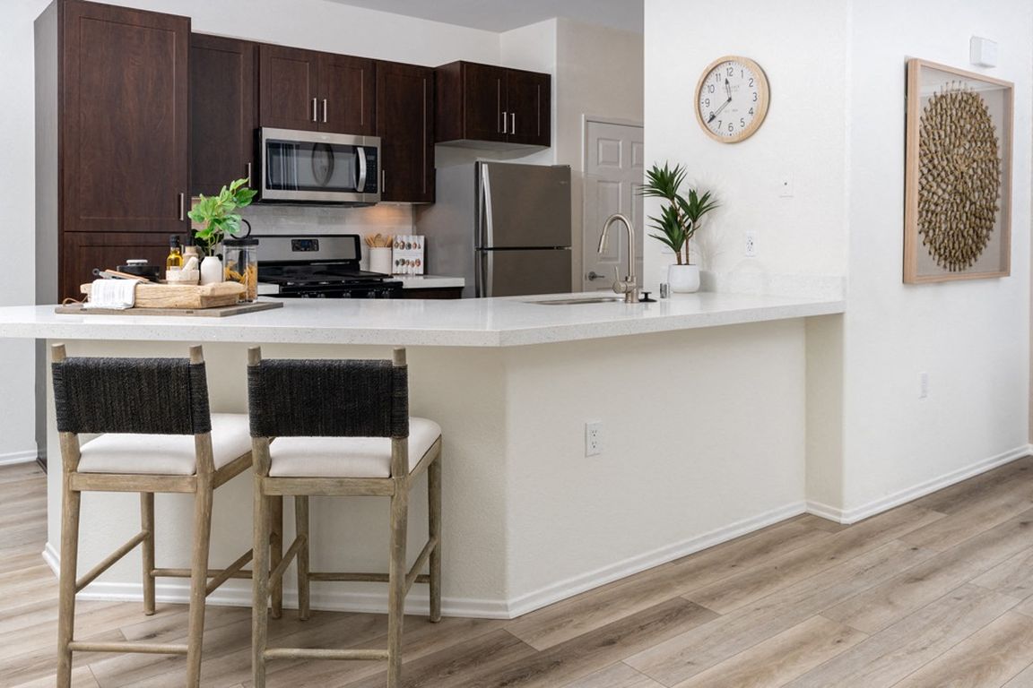 Bright Kitchen with Extended Countertop Seating and Decorative Wall Art