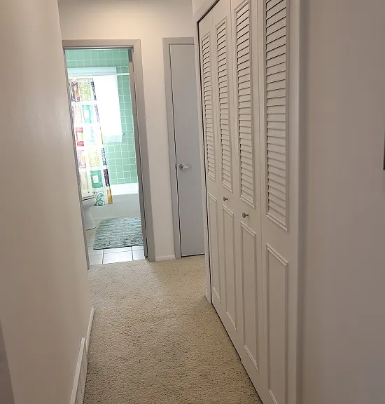 Looking down the hallway toward the bathrooms and bedrooms. Laundry is on the right.