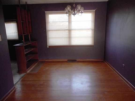 Dining, wood flooring, bookcase