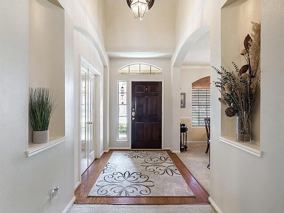 Your foyer greets you with high ceilings, beautiful wood floors, arches and niches to display your favorite pieces!