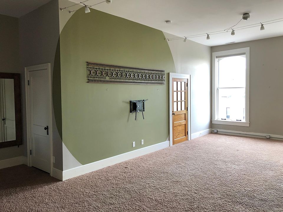 Living room with coat closet door at left, and north bedroom door at right.