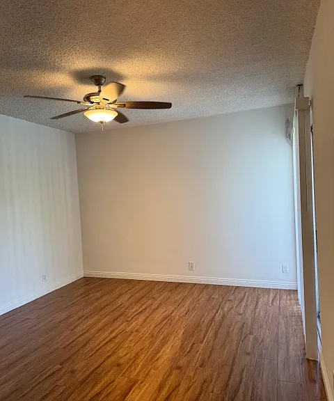 View of same room that has sliding glass door to balcony on right
