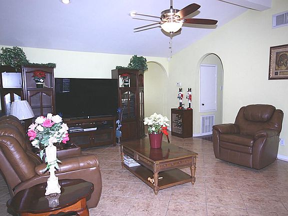 Arched doorways run throughout.  This large family room has oversized tile laid on the diagonal.