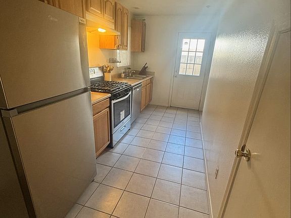 Galley kitchen (pantry & storage on right below stairs).
